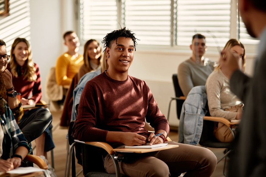 happy african american college student listening lecture in the classroom.